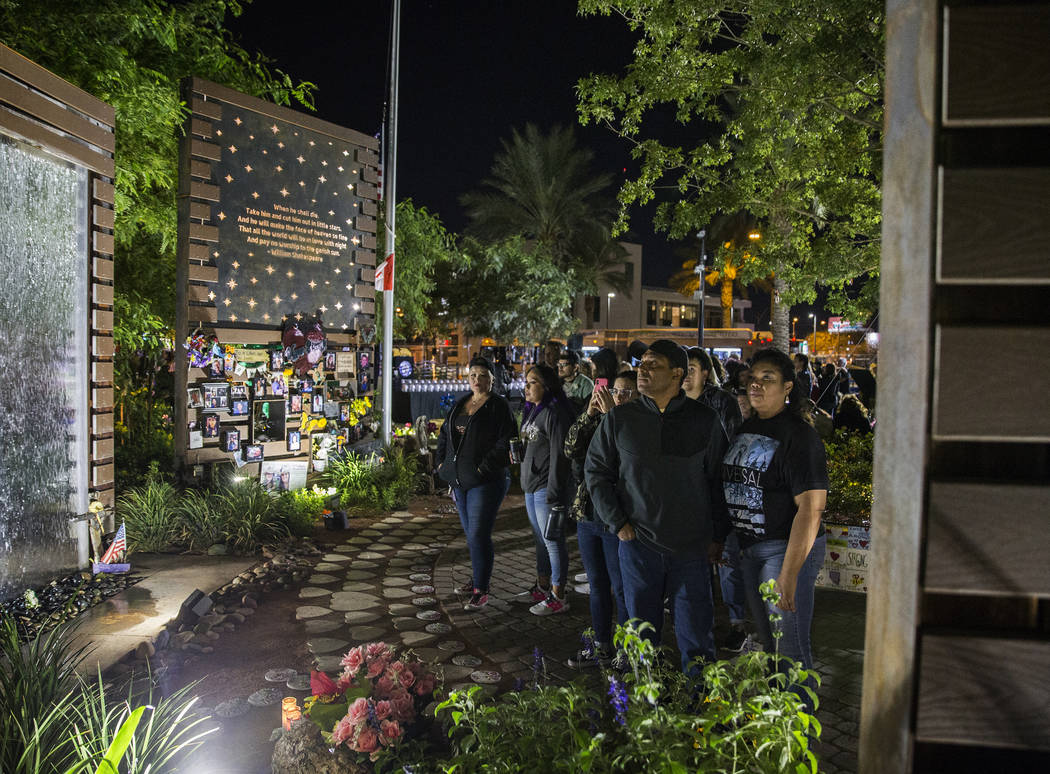 Visitors walk through the Las Vegas Community Healing Garden before the start of a ceremony hon ...