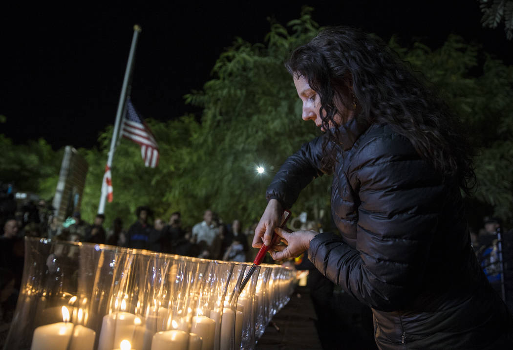 Mauricia Baca lights candles honoring the 58 victims of the Route 91 Harvest festival shooting ...