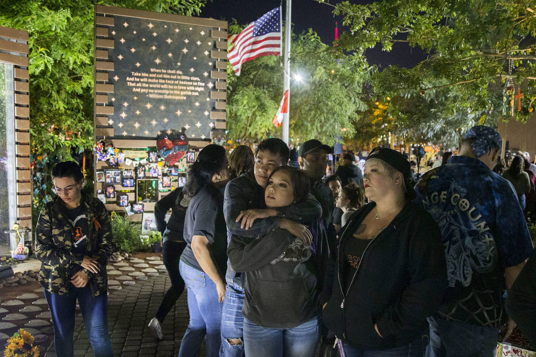 Cydnee Gomez, center, gets a hug from Cameron Bonifacio as they walk through the Las Vegas Comm ...