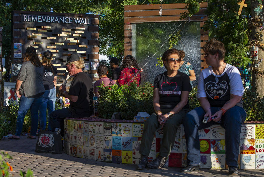 Tod Mainzer, left, plays the recorder as visitors take time out at the Las Vegas Healing Garden ...