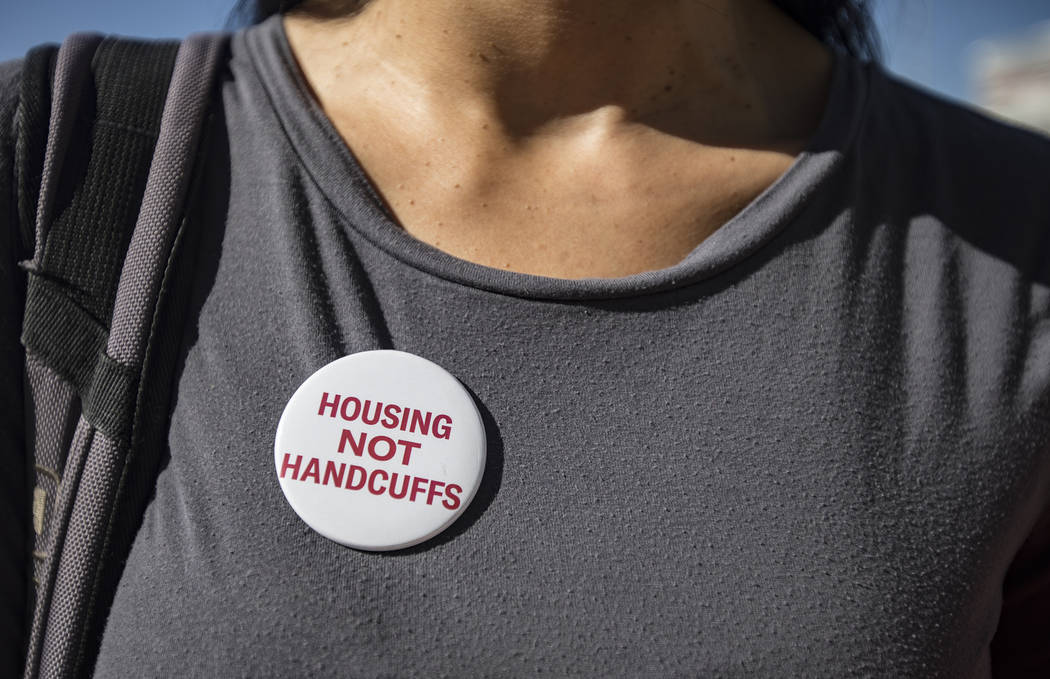 Merideth Spriggs, founder of the nonprofit Caridad, wears a button in protest against a propose ...