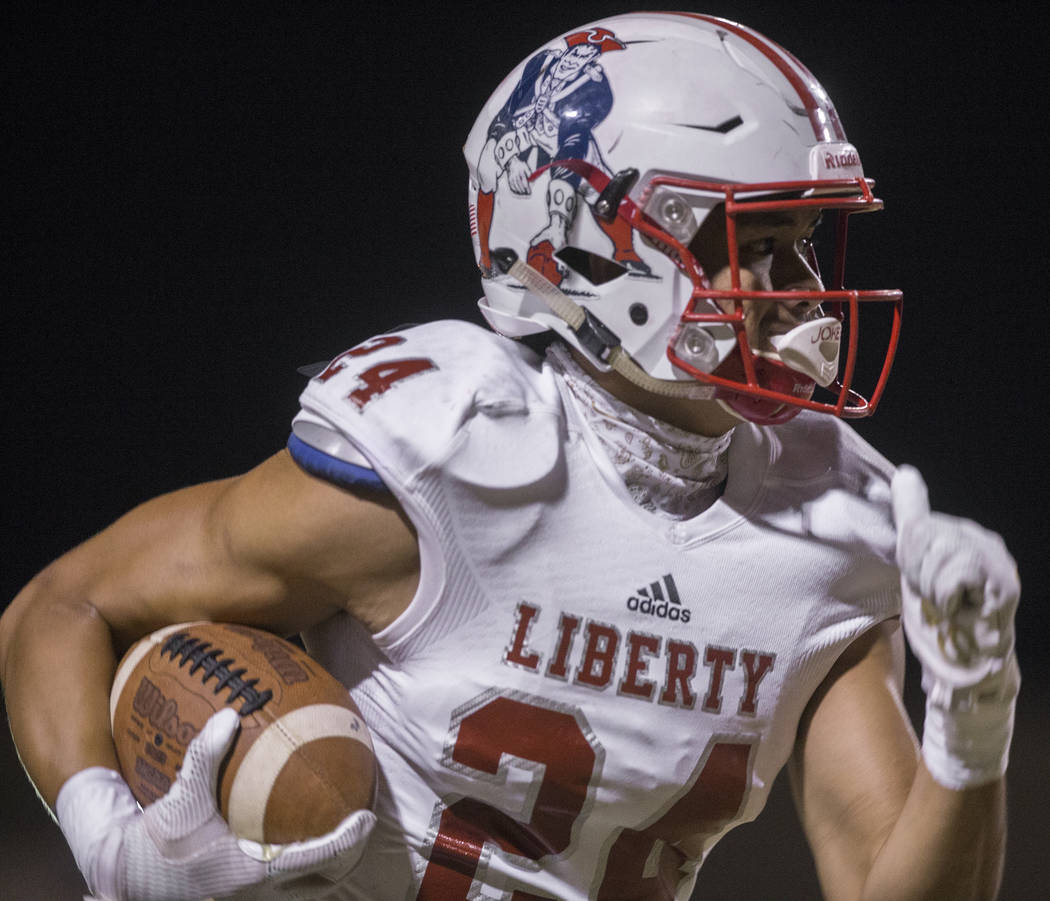 Liberty senior safety Lehi Ausage (24) returns an interception for a touchdown in the first qua ...