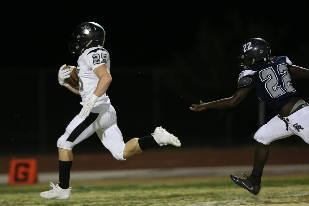 Palo Verde's Dacen Phister (25) runs for a touchdown with Shadow Ridge's Anthony Wheaton (22) r ...