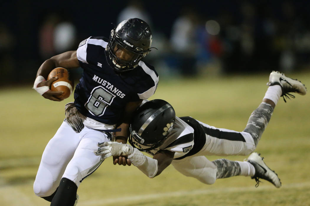 Shadow Ridge's Marrion Macklin-Thomas (6) is tackled by Palo Verde's Adrian Ellis (7) in the fi ...