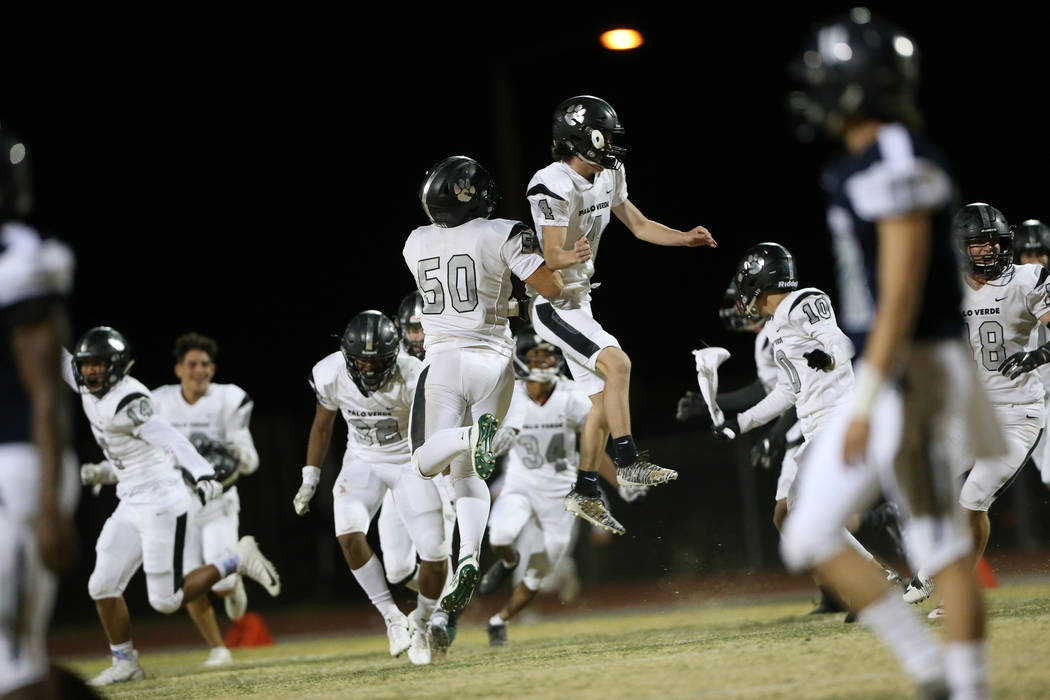 Players from Palo Verde including Bogdan Filipovic (50) and Joey Caifano (4) celebrate their wi ...
