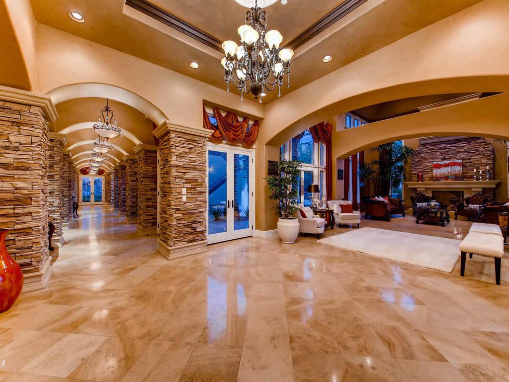 The estate showcases imported French limestone flooring, coffered ceilings and natural stone ac ...
