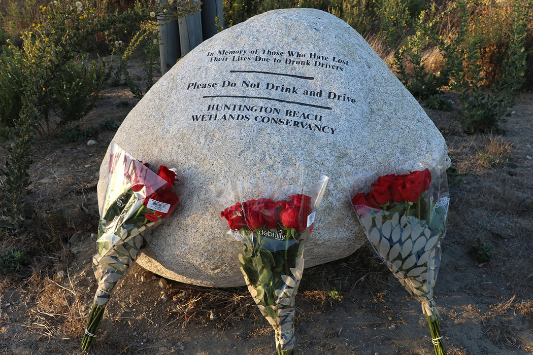 Three bouquets of roses, one for each of teens killed in a fiery crash last year in Huntington ...