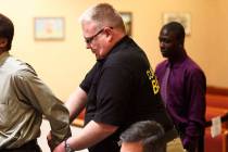 Bailiff Jered Pace, center, removes handcuffs from a defendant in North Las Vegas Justice Court ...