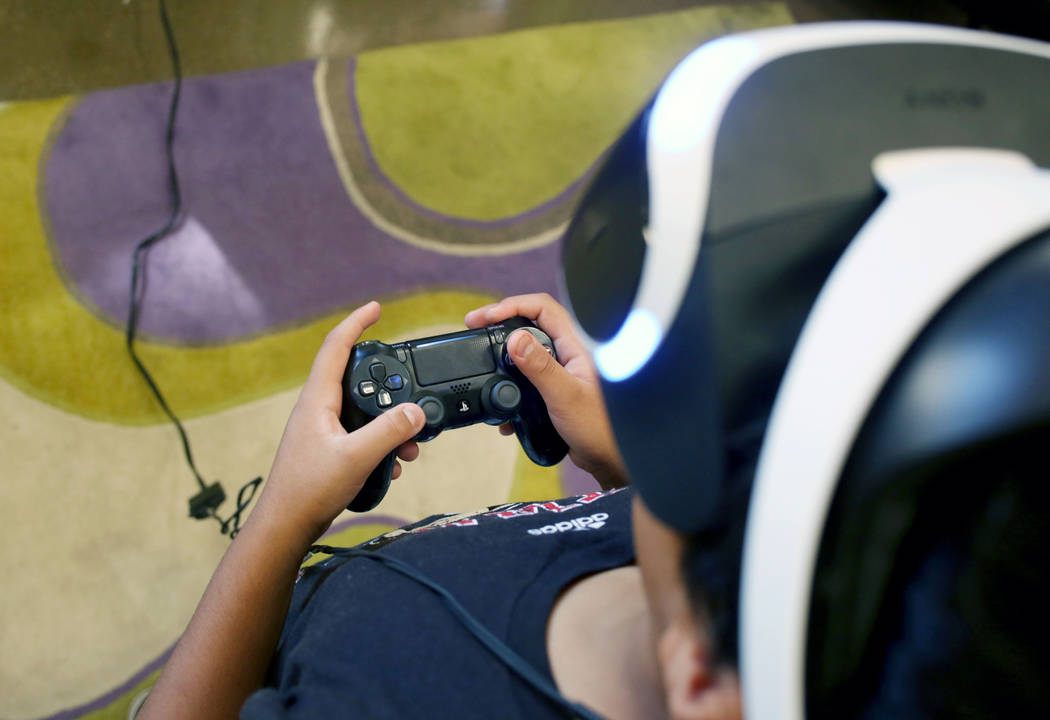 Alexis, 14, Henderson, plays Playstation 4 VR at the teen center at Green Valley Library in Hen ...
