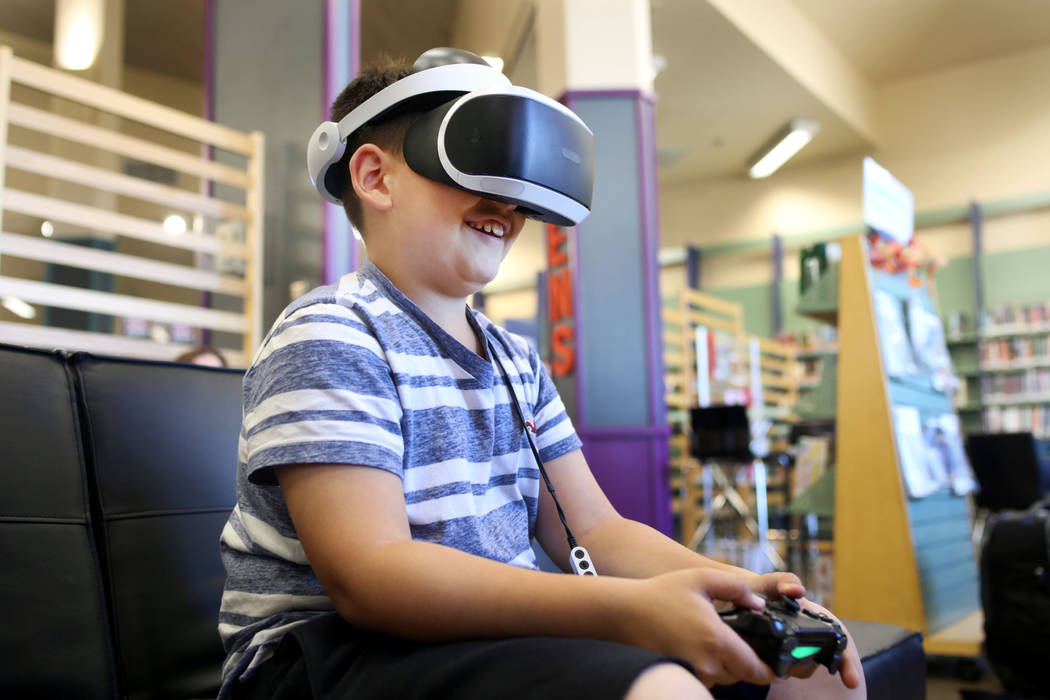 Dominic Giorgi, 10, Henderson, plays a PlayStation 4 VR game in the teen center at Green Valley ...