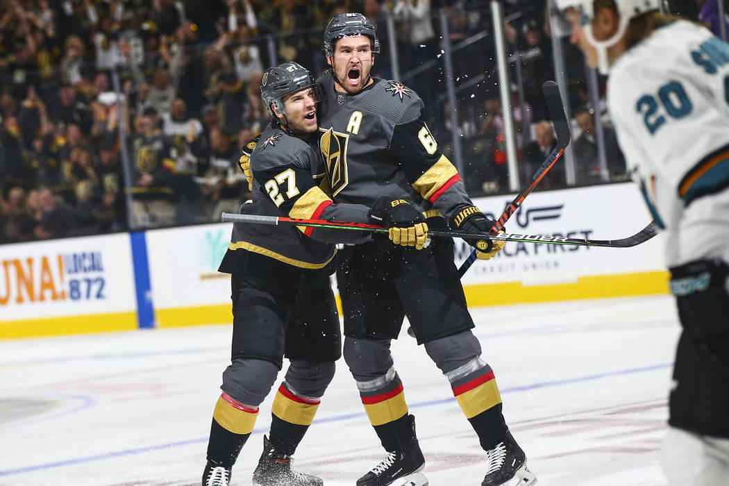 Golden Knights' Mark Stone, right, celebrates his goal with Shea Theodore (27) during the first ...