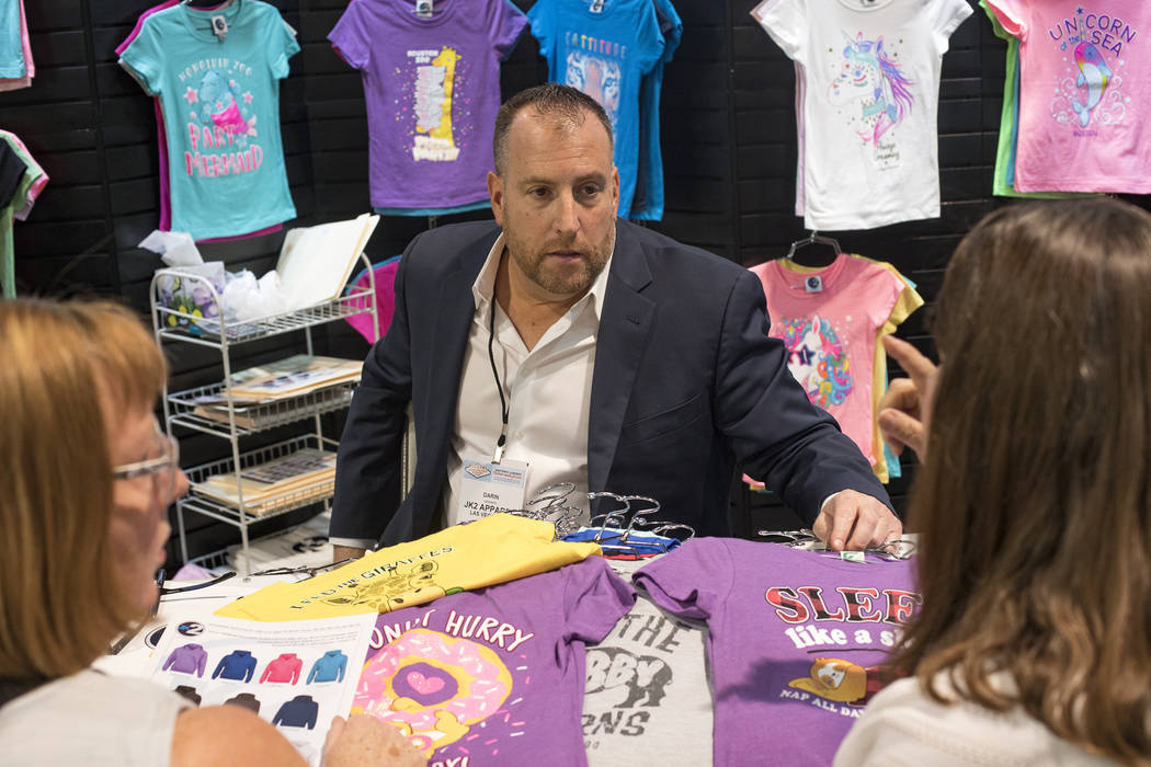 Darin Lefkowitz, CEO of JK2, a company that sells kids apparel, talks to customers Sheila Wewer ...