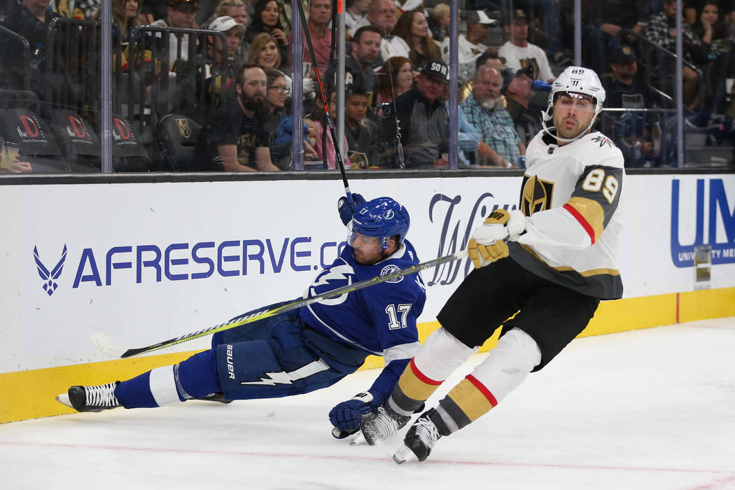 Tampa Bay Lightning left wing Alex Killorn (17) takes a fall while defending against Vegas Gold ...