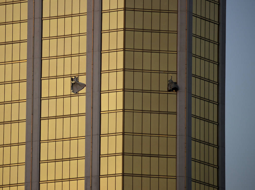 Drapes billow out of broken windows at Mandalay Bay on the Las Vegas Strip on Oct. 2, 2017, fol ...