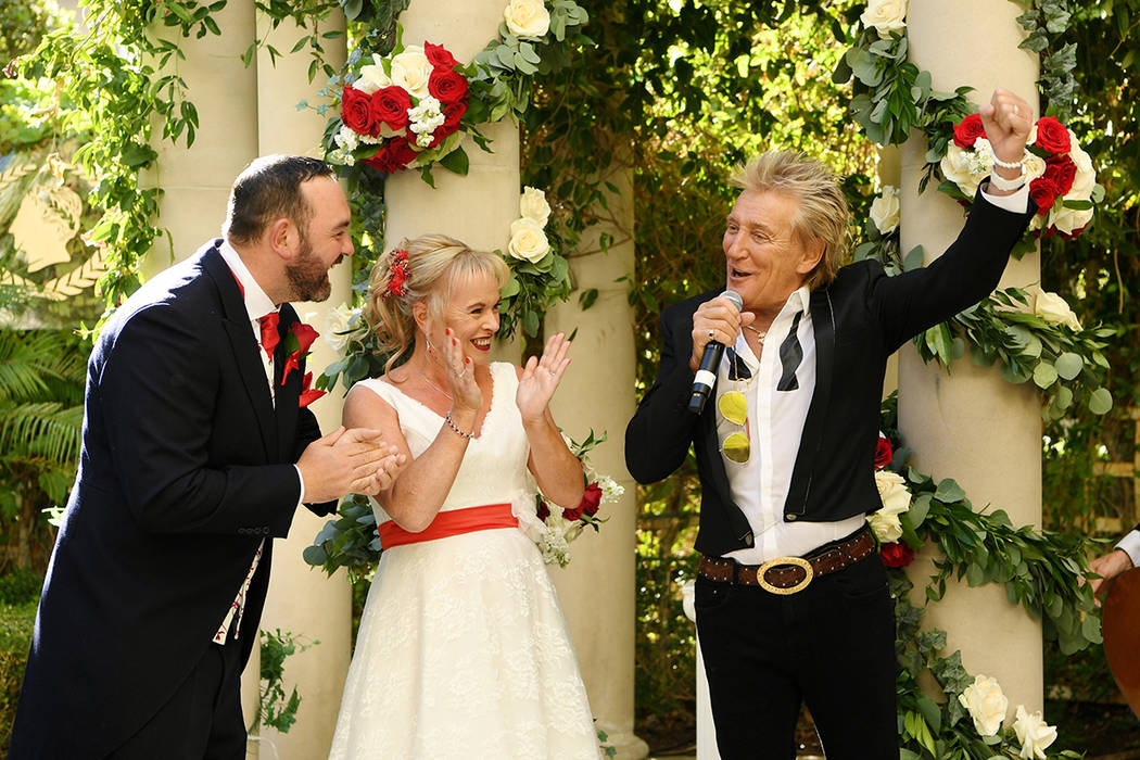 Rock legend Rod Stewart is shown with Sharon Cook and Andrew Aitchison at the couple's wedding ...