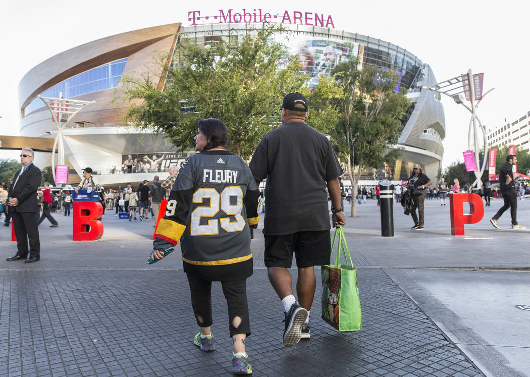 Elena Leger, left, holds hands with boyfriend Fernando Agundez as they walk towards T-Mobile Ar ...