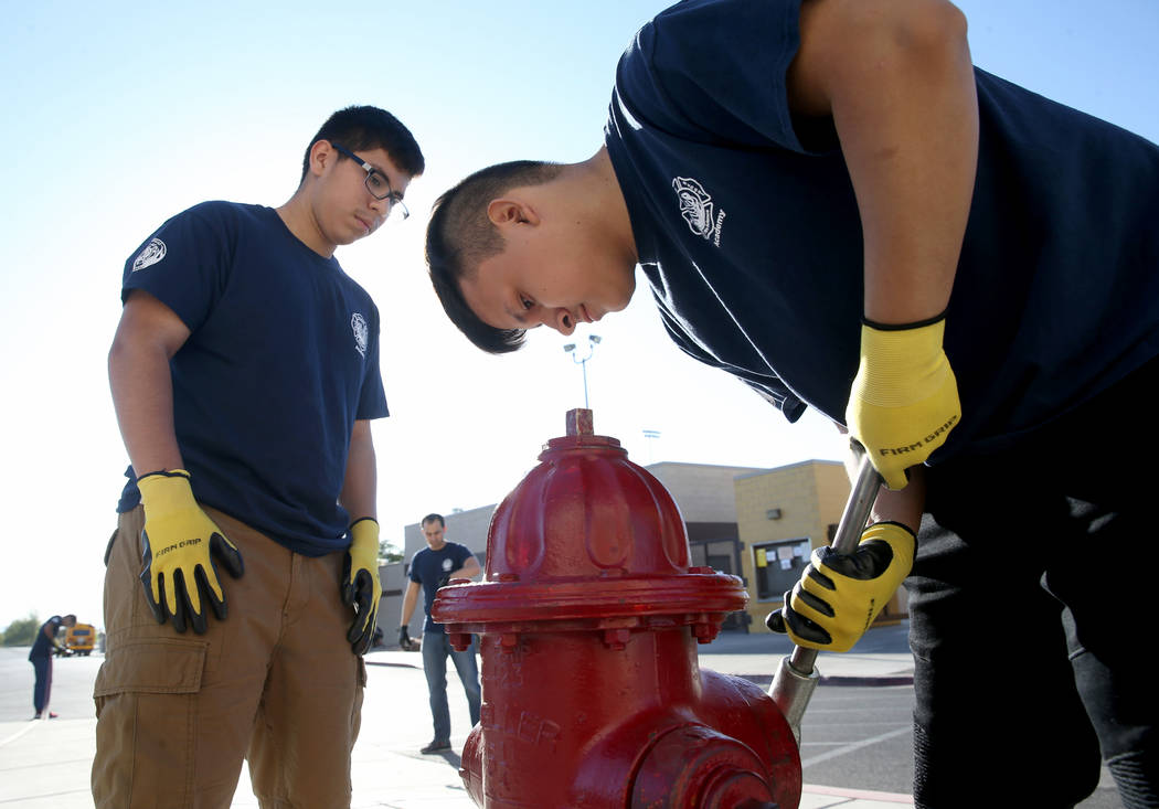 Bonanza High School Fire Science Academy junior Gerardo Bucio, left, and Edgar Linares prepare ...