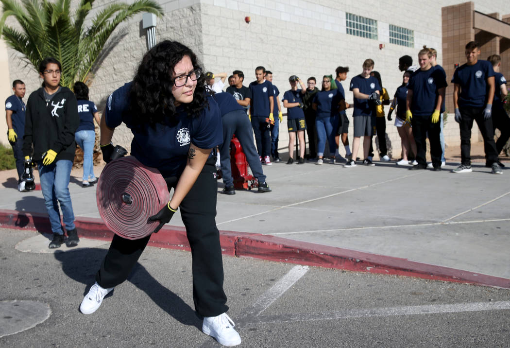 Bonanza High School Fire Science Academy student Julie Mendez rolls out a hose during fire cert ...
