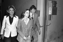 FILE - In this April 12, 1976 file photo, accompanied by deputy U.S. Marshal John Brophy, Patty ...