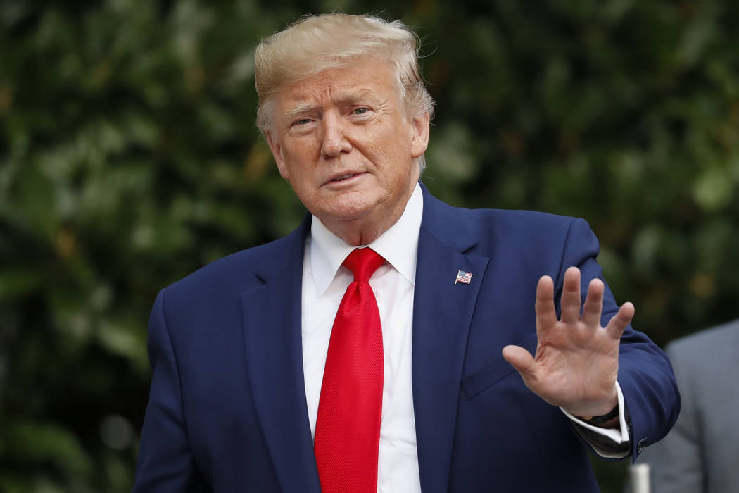 President Donald Trump gestures towards members of the media on the South Lawn of the White Hou ...