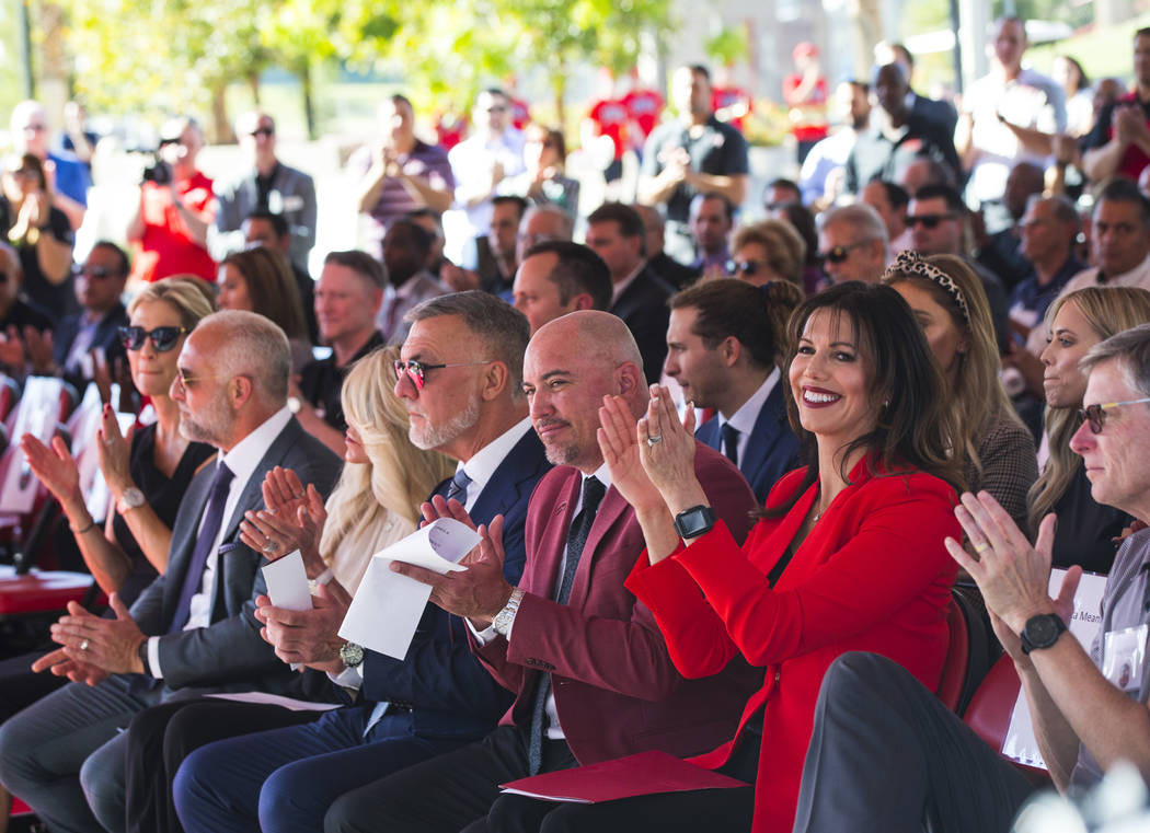 UNLV football coach Tony Sanchez, center, claps alongside Frank Fertitta III, center left, and ...