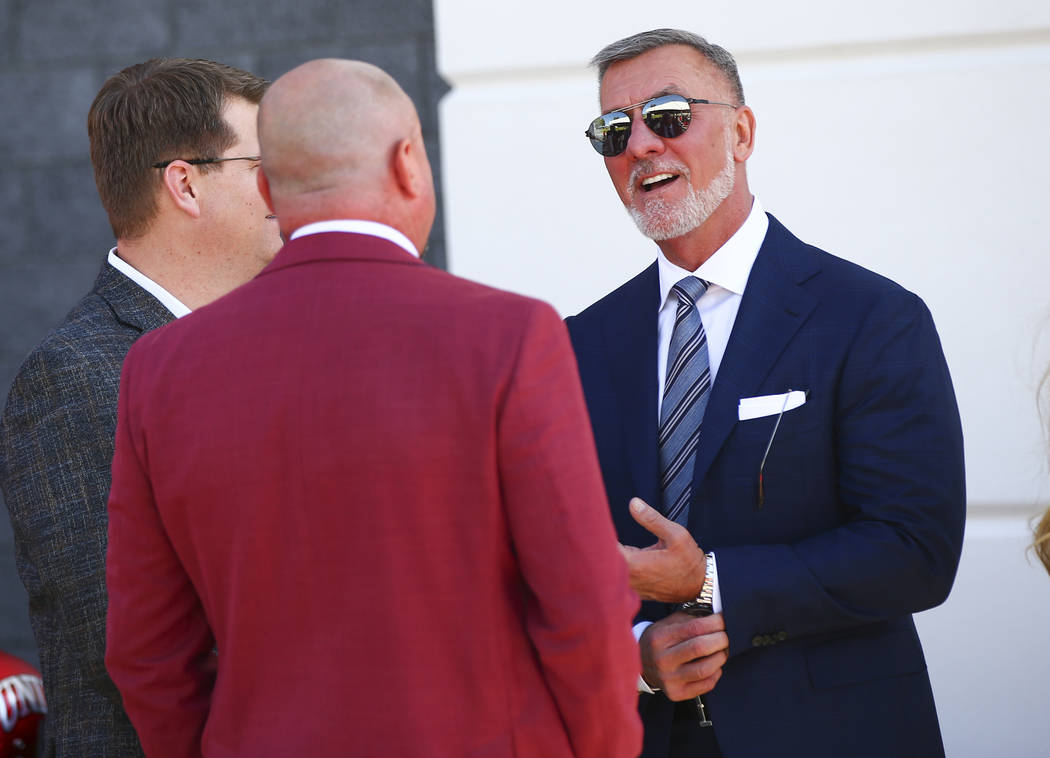 Frank Fertitta III, right, talks with UNLV football coach Tony Sanchez before the start of a ri ...