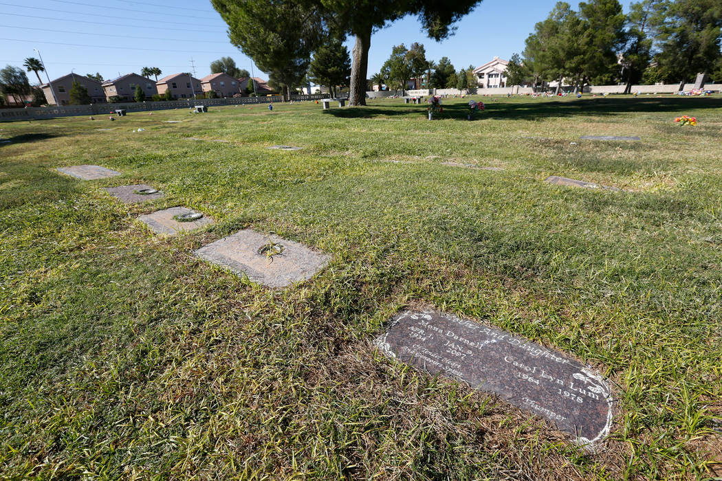 The headstone of Carol Lyn Lum, a 14-year-old girl who was killed in 1978, and her mother, Mona ...
