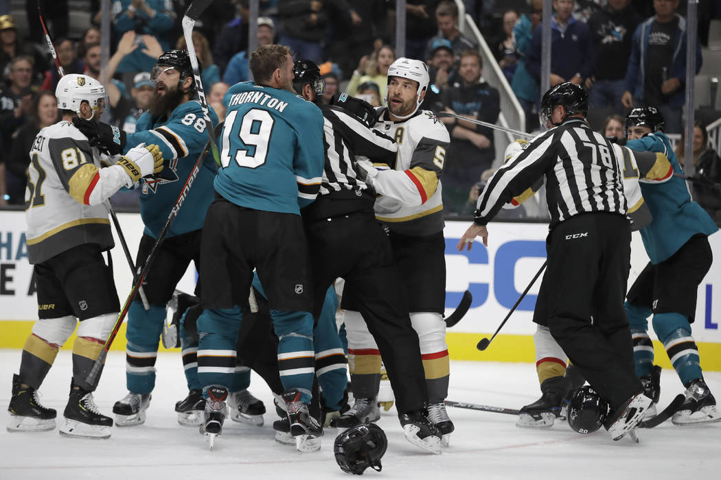 Officials try to stop a multi-player fight between the Vegas Golden Knights and the San Jose Sh ...