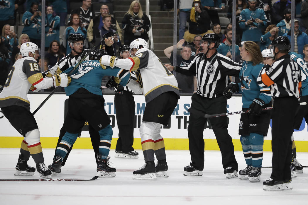 Officials try to stop a multi-player fight between the Vegas Golden Knights and the San Jose Sh ...
