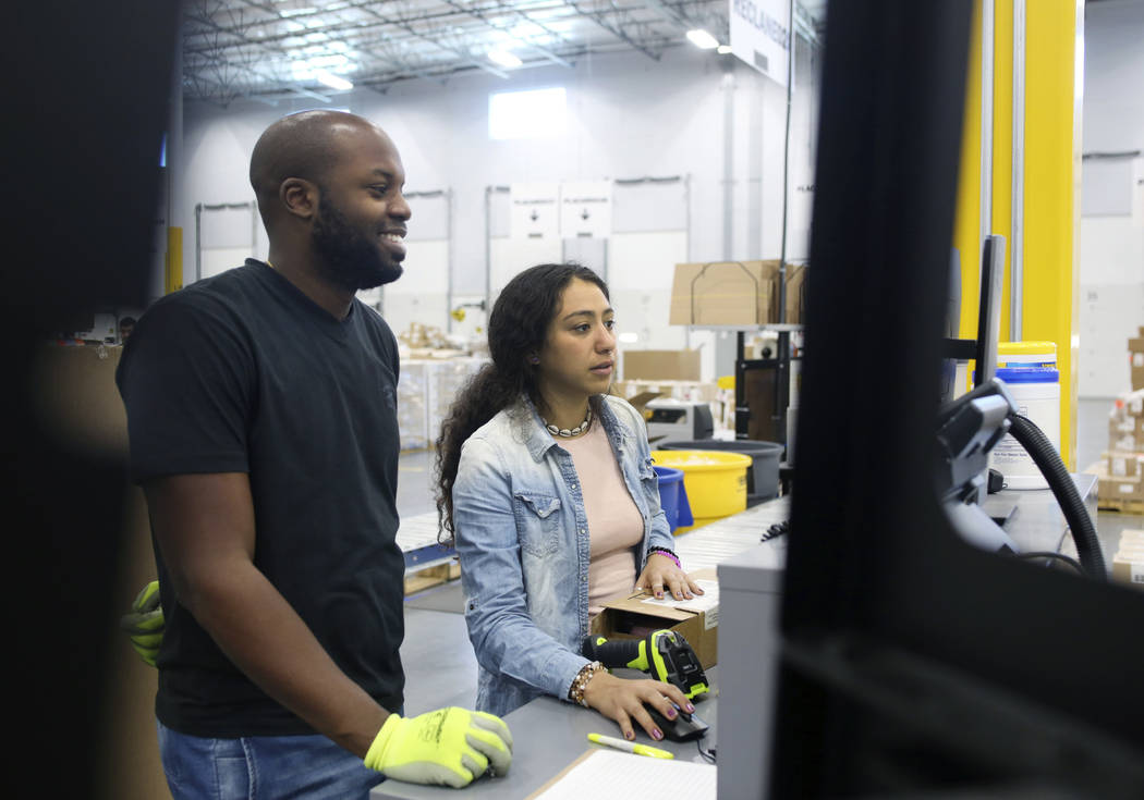 Cubic scanner Tomas Gonzalez, left, and inbound specialist Brittany Uscanga, log product at th ...