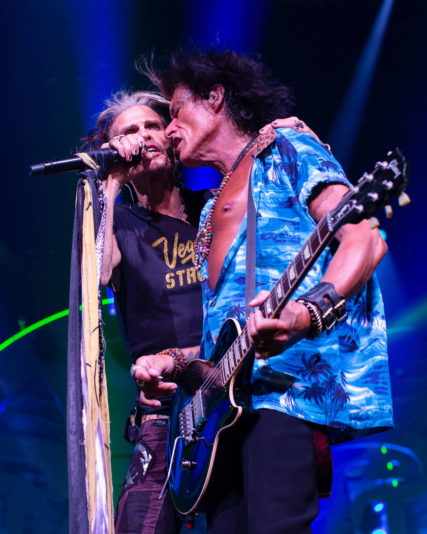 Aerosmith front man Steven Tyler sports his Vegas Strong T-shirt while performing with Joe Perr ...