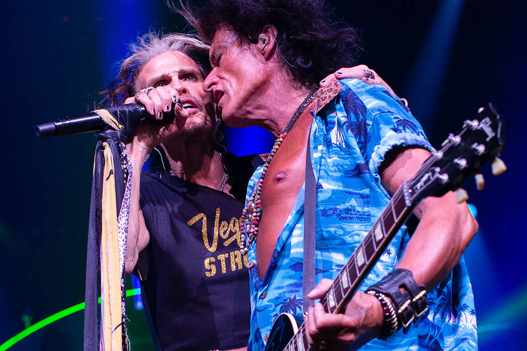 Aerosmith front man Steven Tyler sports his Vegas Strong T-shirt while performing with Joe Perr ...