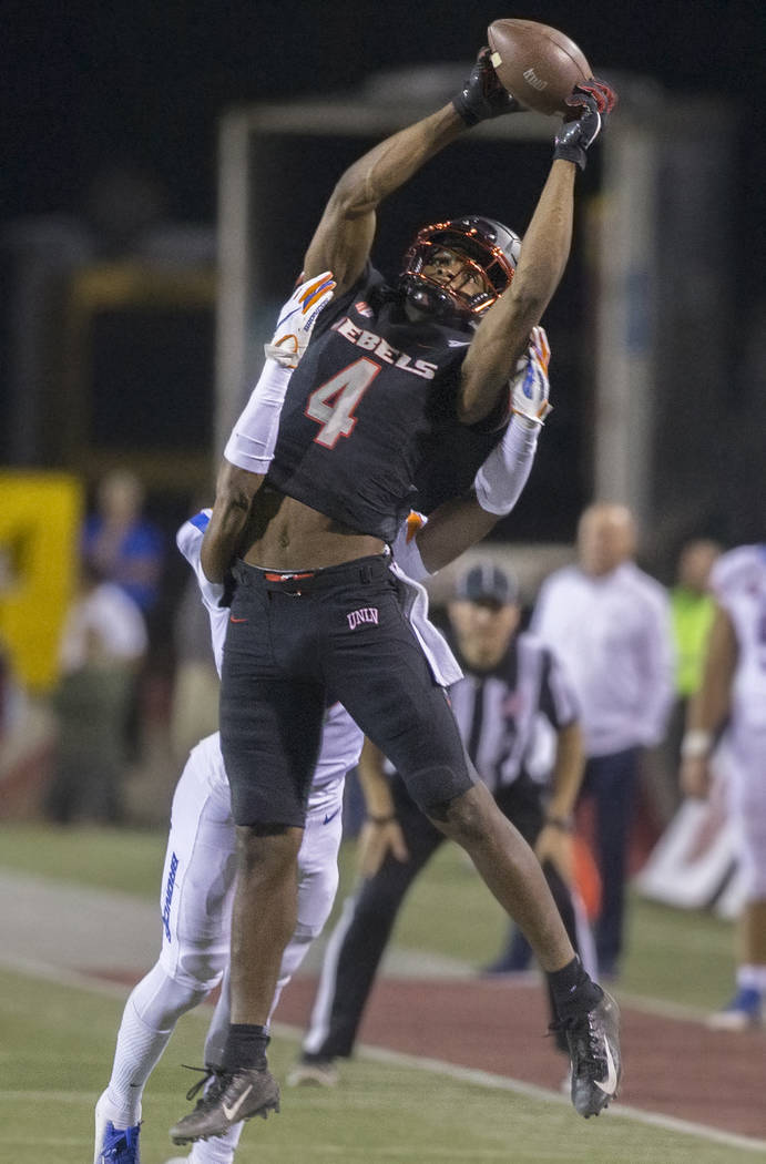 UNLV Rebels wide receiver Randal Grimes (4) makes an acrobatic catch over a Boise State defende ...