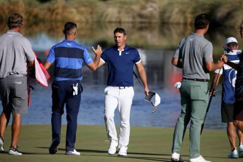 Brooks Koepka shakes hands with Gary Woodland after finishing up on the 18th hole during second ...