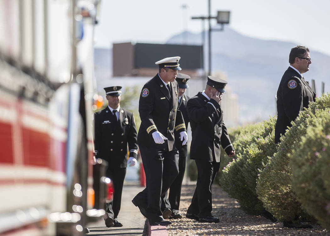 Henderson Fire and Police Department personnel make their way into Central Church to honor the ...
