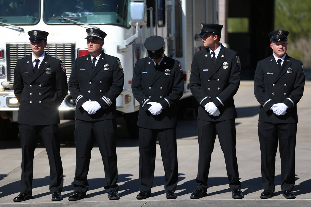 Firefighters stand outside of the Henderson Fire Station 97 in Henderson to watch the funeral p ...