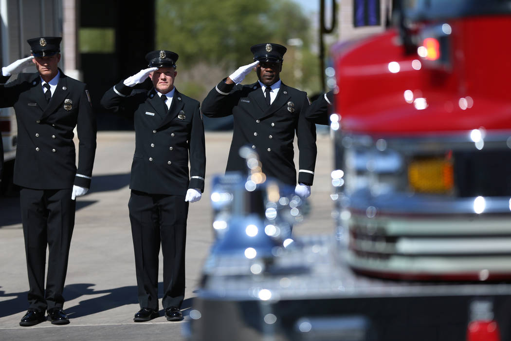 Firefighters salute during the funeral procession for firefighter Robbie James Pettingill outsi ...
