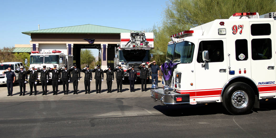 Firefighters stand outside of the Henderson Fire Station 97 in Henderson to watch the funeral p ...