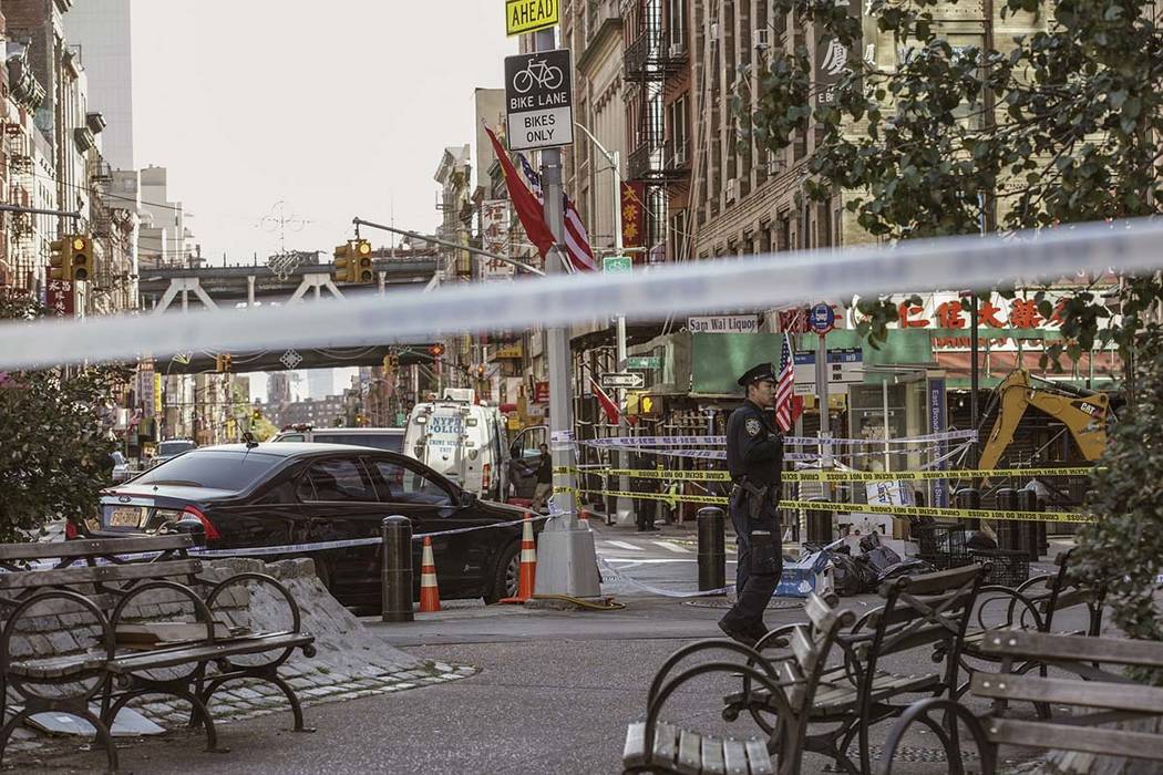 New York Police Department officers investigate the scene of an attack in Manhattan's Chinatown ...
