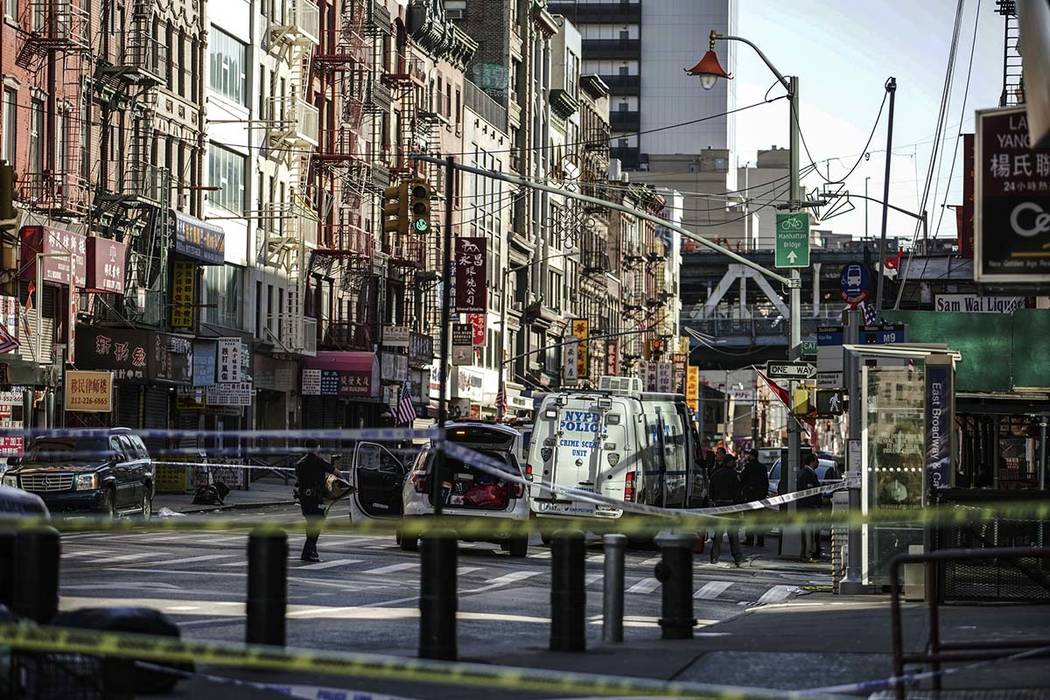 New York Police Department officers investigate the scene of an attack in Manhattan's Chinatown ...