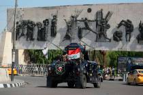 Iraqi security forces arrive near the site of the protests in Tahrir square, central Baghdad, I ...