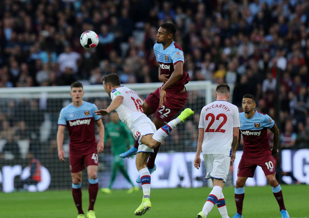 West Ham United forward Sebastien Haller (22) heads the soccer ball as he collides with Crystal ...