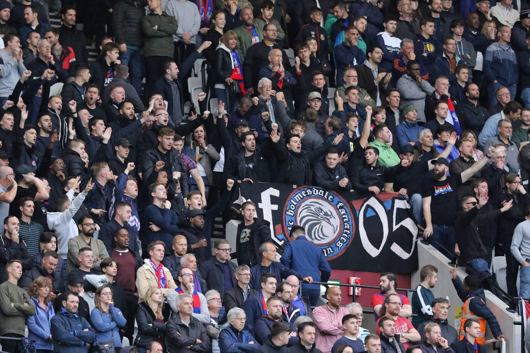 Soccer fans cheer during the first half of an English Premier League soccer match between the W ...