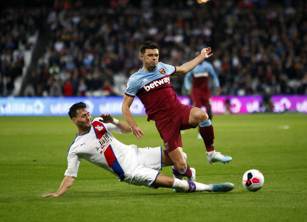 West Ham United defender Aaron Cresswell (3) attempts to kick the ball away from Crystal Palace ...