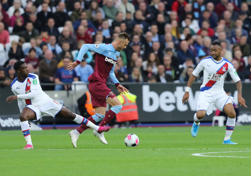 Crystal Palace defender Jeffrey Schlupp (15) tries to get the ball from West Ham United forward ...