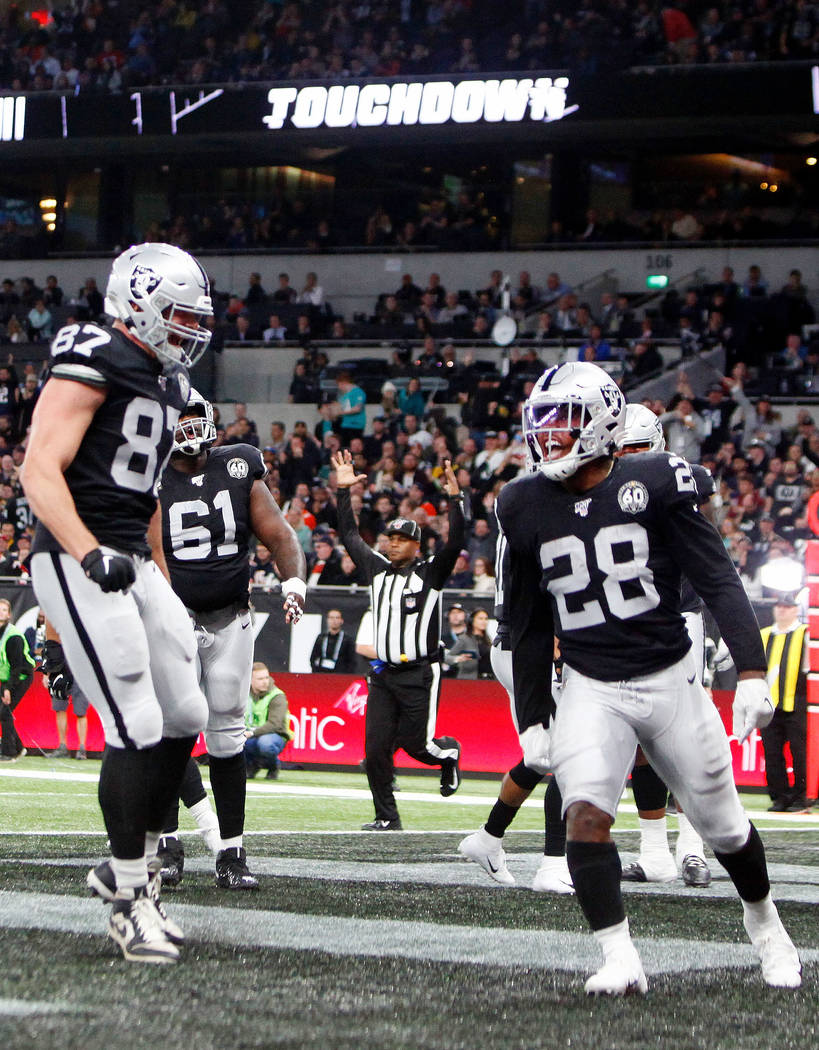 Oakland Raiders tight end Foster Moreau (87) congratulates running back Josh Jacobs (28) on sco ...