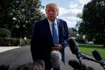 President Donald Trump talks to reporters on the South Lawn of the White House, Friday, Oct. 4, ...