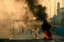 Iraqi security forces fire tear gas to disperse anti-government protesters who set fires and cl ...