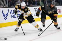 Boston Bruins left wing Brad Marchand (63) skates towards the puck as Vegas Golden Knights defe ...