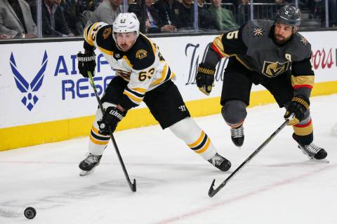 Boston Bruins left wing Brad Marchand (63) skates towards the puck as Vegas Golden Knights defe ...